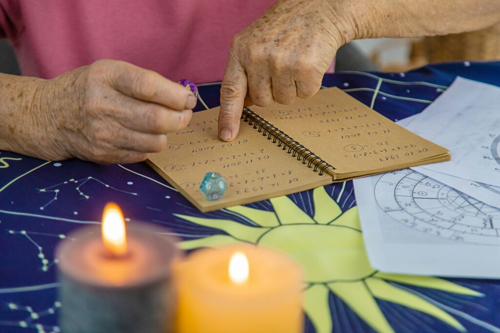 Woman numerologist astrologer counts numbers. Selective focus. People.